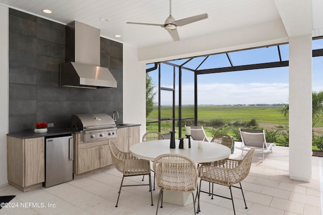 view of terrace featuring an outdoor kitchen, ceiling fan, and grilling area