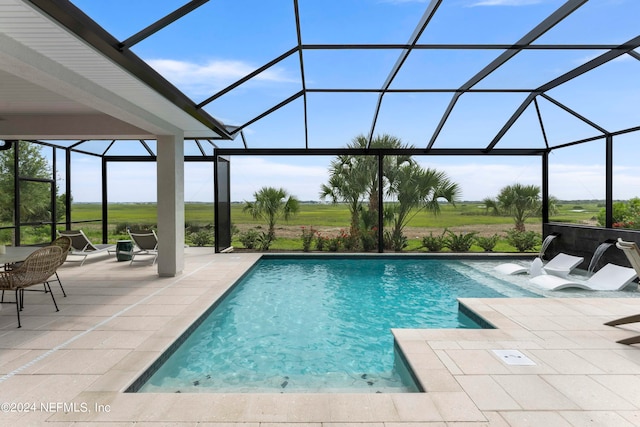 view of swimming pool with a patio area and glass enclosure