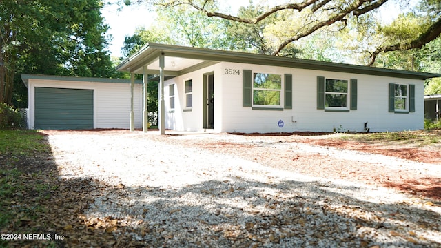 single story home featuring an outdoor structure and a garage