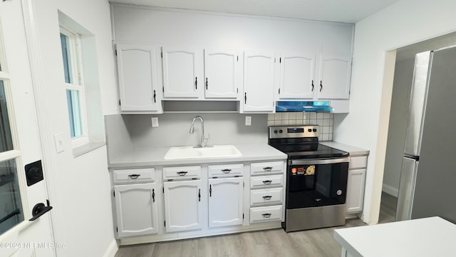 kitchen featuring light hardwood / wood-style flooring, stainless steel appliances, white cabinetry, and sink