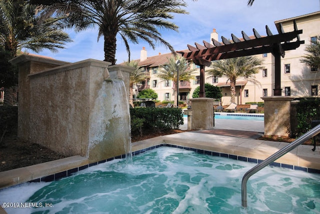 view of swimming pool featuring a community hot tub