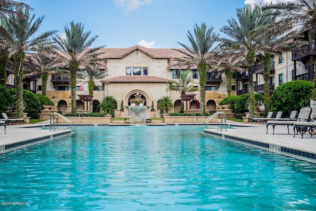 view of swimming pool with pool water feature