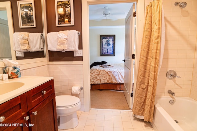 full bathroom featuring tile patterned floors, toilet, tile walls, shower / tub combo, and vanity