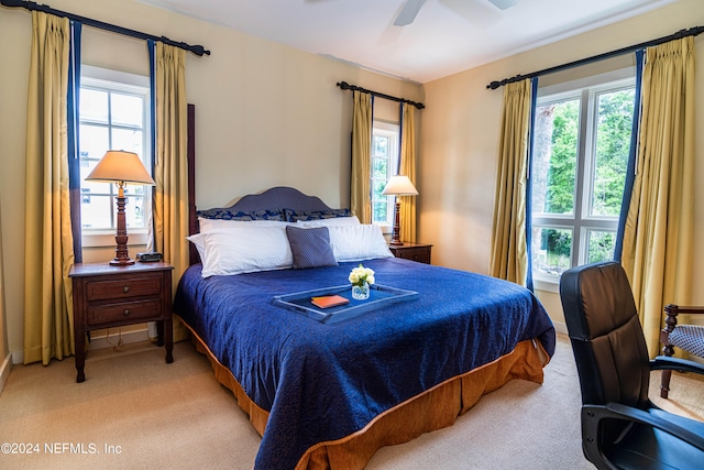 bedroom with light colored carpet and ceiling fan