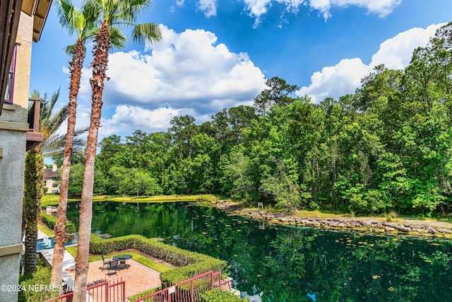 view of yard featuring a water view and a patio