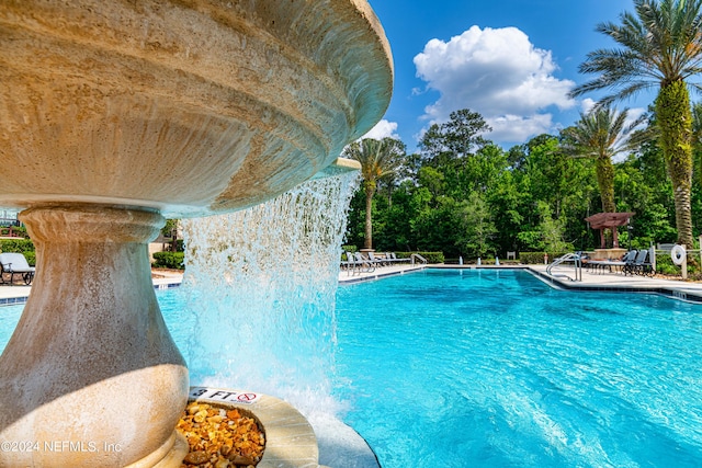 view of pool featuring pool water feature and a patio area