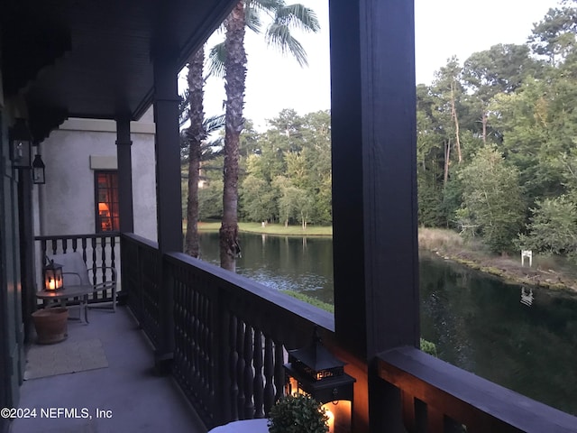 sunroom featuring a water view