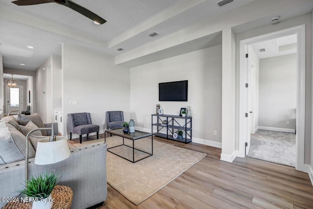 living room featuring ceiling fan and hardwood / wood-style floors