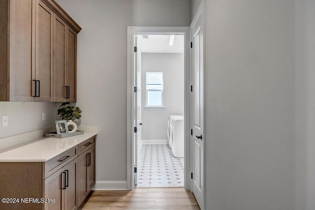 interior space with washer and dryer and light wood-type flooring