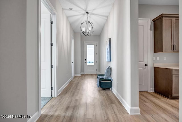 interior space featuring light hardwood / wood-style floors and a notable chandelier