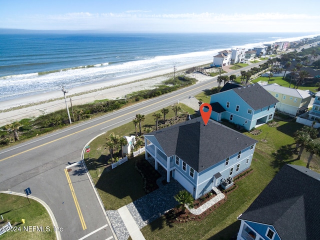 bird's eye view featuring a view of the beach and a water view