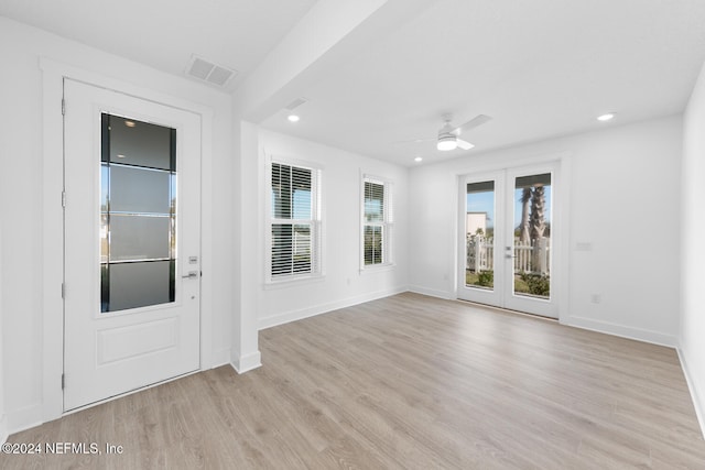 empty room with ceiling fan and light wood-type flooring