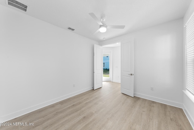 spare room with light hardwood / wood-style flooring and ceiling fan