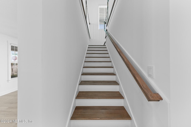 stairs featuring hardwood / wood-style flooring