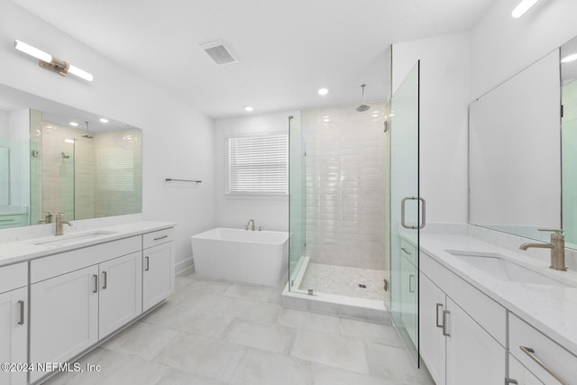 bathroom with vanity and separate shower and tub