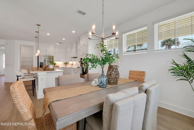 25 Seaside Vista Ct, Saint Augustine, FL 32084 - dining space featuring light wood-style floors, baseboards, a chandelier, and recessed lighting