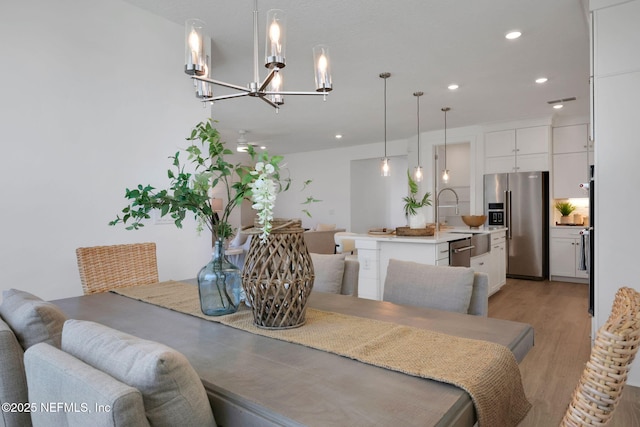 25 Seaside Vista Ct, Saint Augustine, FL 32084 - dining space featuring a chandelier, light wood-style floors, and recessed lighting