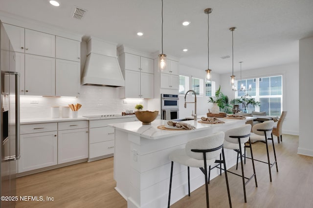 25 Seaside Vista Ct, Saint Augustine, FL 32084 - kitchen featuring custom exhaust hood, a sink, stainless steel appliances, light wood-style floors, and recessed lighting