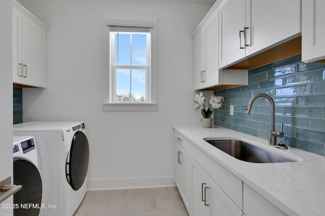25 Seaside Vista Ct, Saint Augustine, FL 32084 - clothes washing area featuring washer and clothes dryer, cabinet space, baseboards, and light tile patterned floors