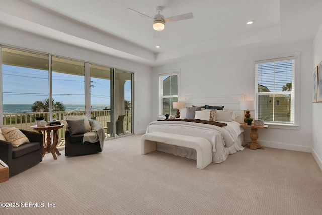25 Seaside Vista Ct, Saint Augustine, FL 32084 - carpeted bedroom with access to exterior, multiple windows, a tray ceiling, baseboards, and recessed lighting
