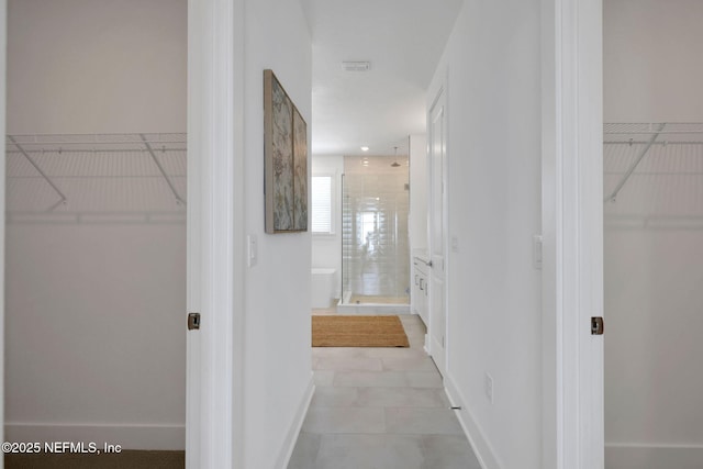 25 Seaside Vista Ct, Saint Augustine, FL 32084 - bathroom featuring a stall shower, a walk in closet, and tile patterned flooring