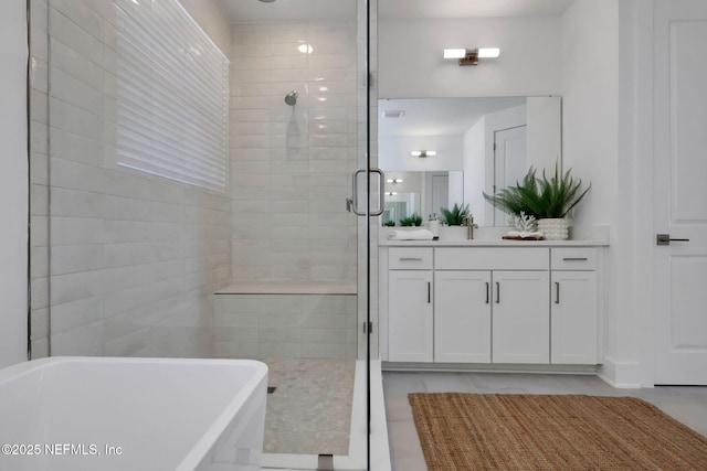 25 Seaside Vista Ct, Saint Augustine, FL 32084 - bathroom with tiled shower, a freestanding bath, tile patterned floors, and vanity