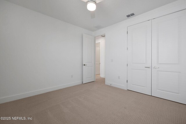 25 Seaside Vista Ct, Saint Augustine, FL 32084 - unfurnished bedroom featuring light carpet, baseboards, a closet, and ceiling fan