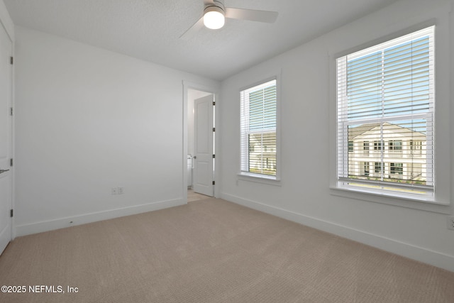 25 Seaside Vista Ct, Saint Augustine, FL 32084 - spare room featuring light carpet, baseboards, healthy amount of natural light, and ceiling fan
