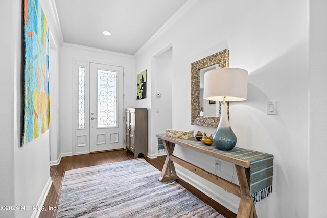 foyer entrance with crown molding and dark hardwood / wood-style floors