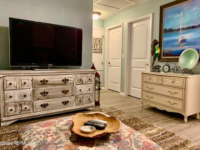 sitting room featuring light wood-type flooring and a textured ceiling