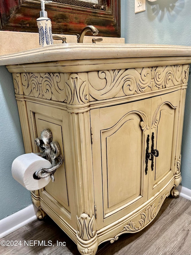 room details featuring vanity and hardwood / wood-style flooring