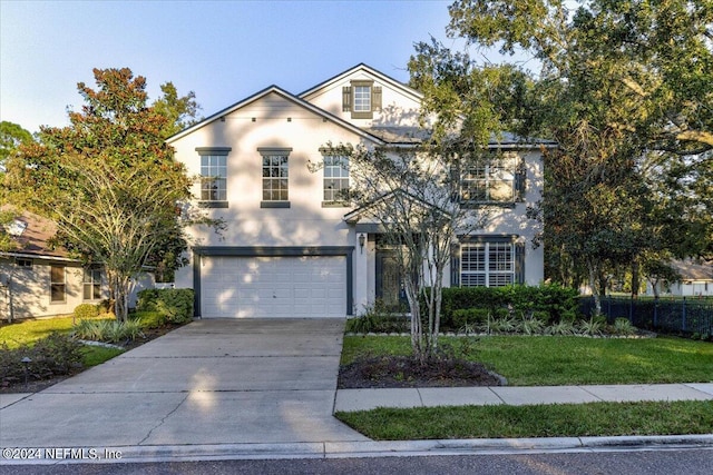 front facade featuring a front yard and a garage