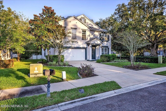 view of front of house featuring a front yard and a garage