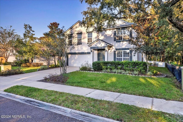 view of front of house with a front yard and a garage