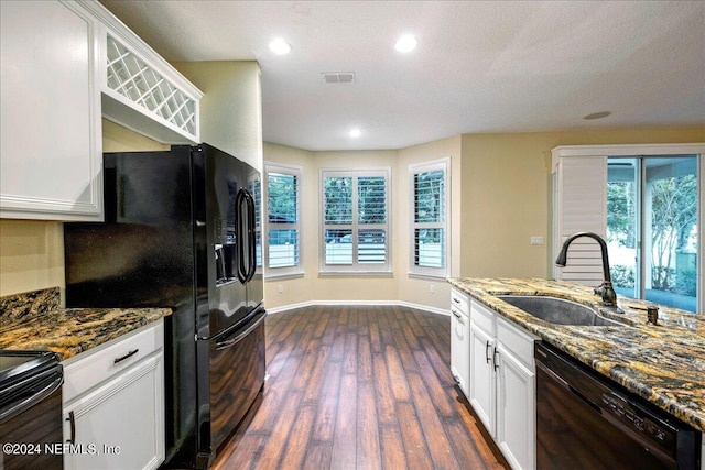 kitchen with white cabinetry, black appliances, sink, and plenty of natural light