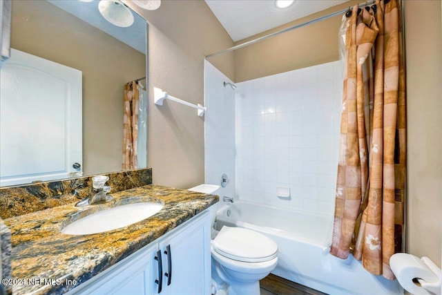 full bathroom featuring toilet, wood-type flooring, shower / tub combo with curtain, vanity, and a textured ceiling