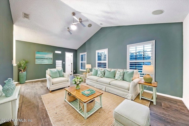 living room featuring a textured ceiling, vaulted ceiling, hardwood / wood-style flooring, and ceiling fan