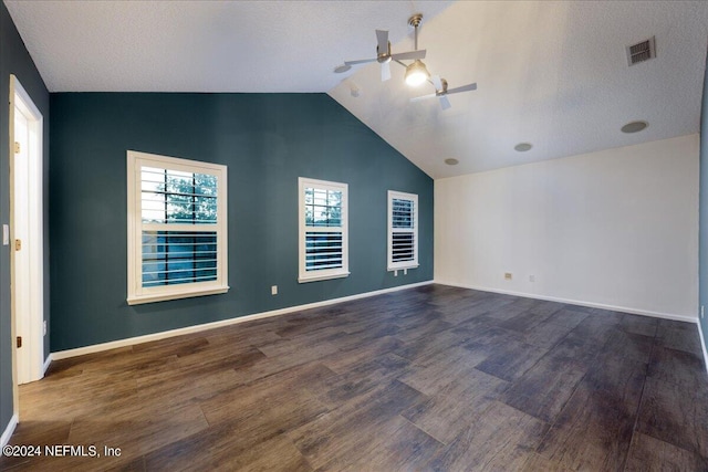 spare room with vaulted ceiling, ceiling fan, a textured ceiling, and dark hardwood / wood-style flooring