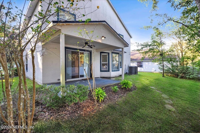 rear view of house featuring a yard, a patio area, central air condition unit, and ceiling fan