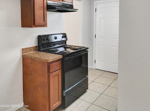 kitchen featuring black electric range and light tile floors