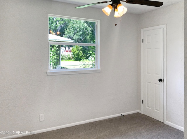 unfurnished room with a healthy amount of sunlight, ceiling fan, and carpet flooring