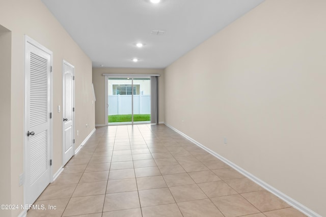 corridor with light tile patterned floors