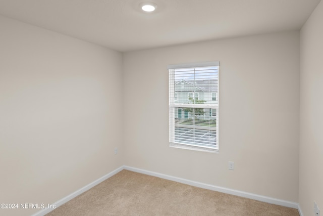 unfurnished room with light carpet