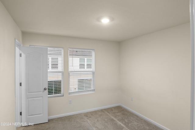 empty room featuring light colored carpet