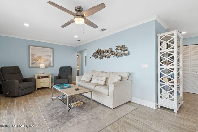 living room with light hardwood / wood-style flooring, crown molding, and ceiling fan