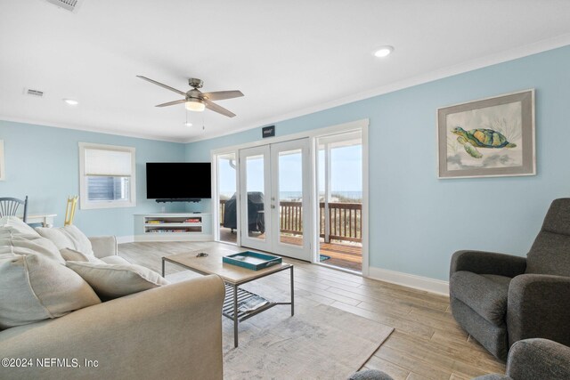 living room featuring ornamental molding, french doors, ceiling fan, and light wood-type flooring