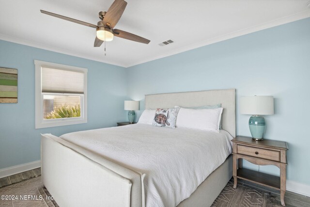 bedroom featuring ornamental molding, ceiling fan, and dark hardwood / wood-style floors