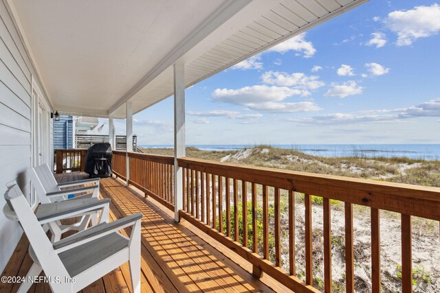 exterior space with a water view and a grill