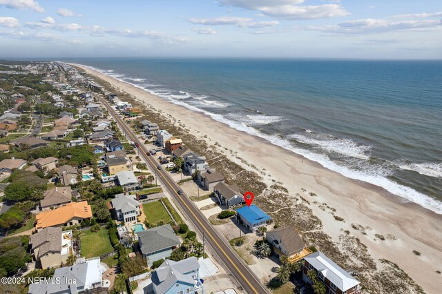 birds eye view of property with a beach view and a water view