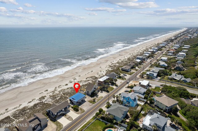 aerial view with a water view and a beach view